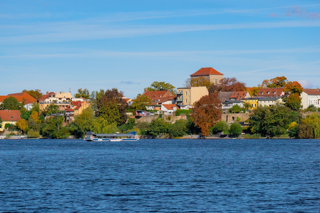Picturesque view of Strausberg across the lake with vibrant autumn foliage.